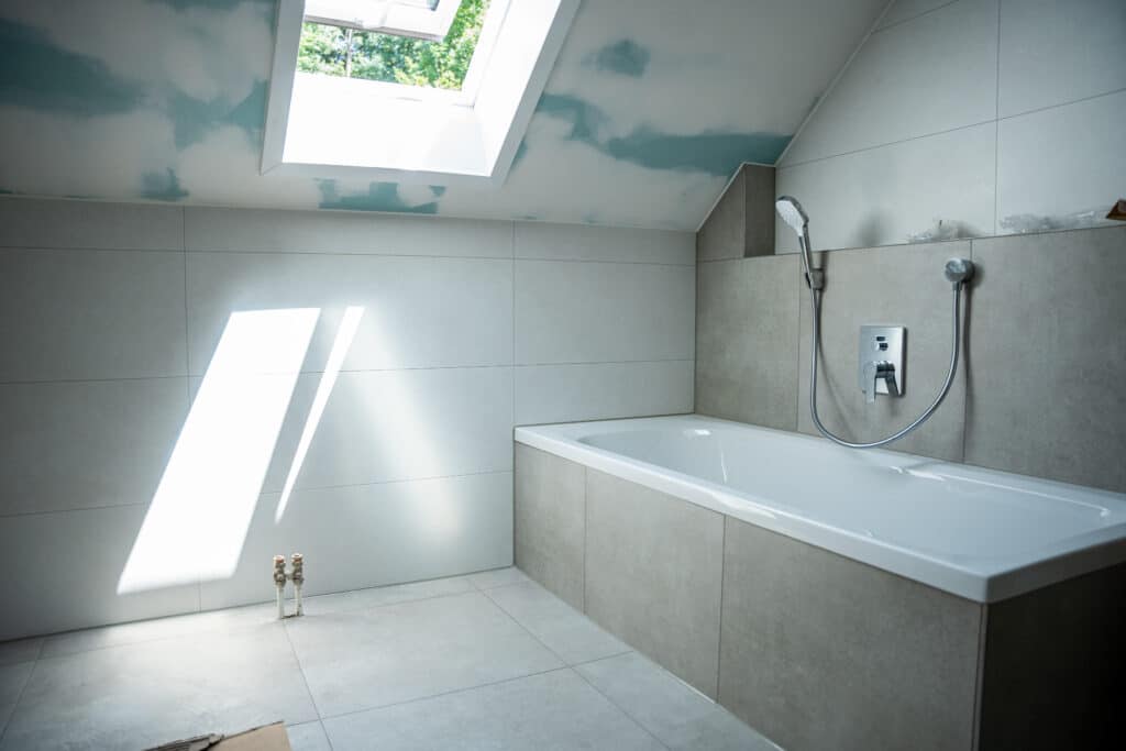 Modernes Badezimmer mit Badewanne und Dachfenster.